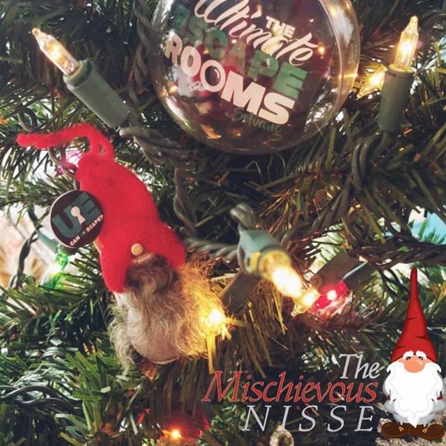 The Mischievous Nisse escape room: a red-hatted Christmas gnome in a lit Christmas tree